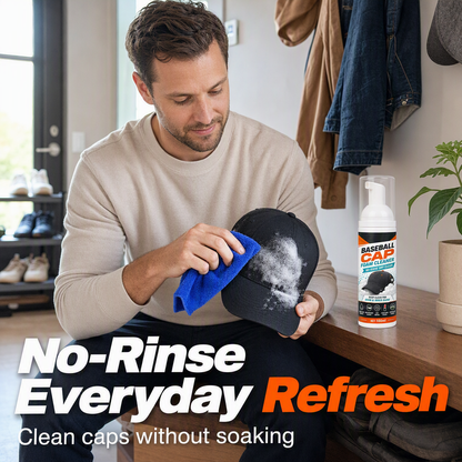 Wiping foam from a black baseball cap with a blue microfiber cloth.
